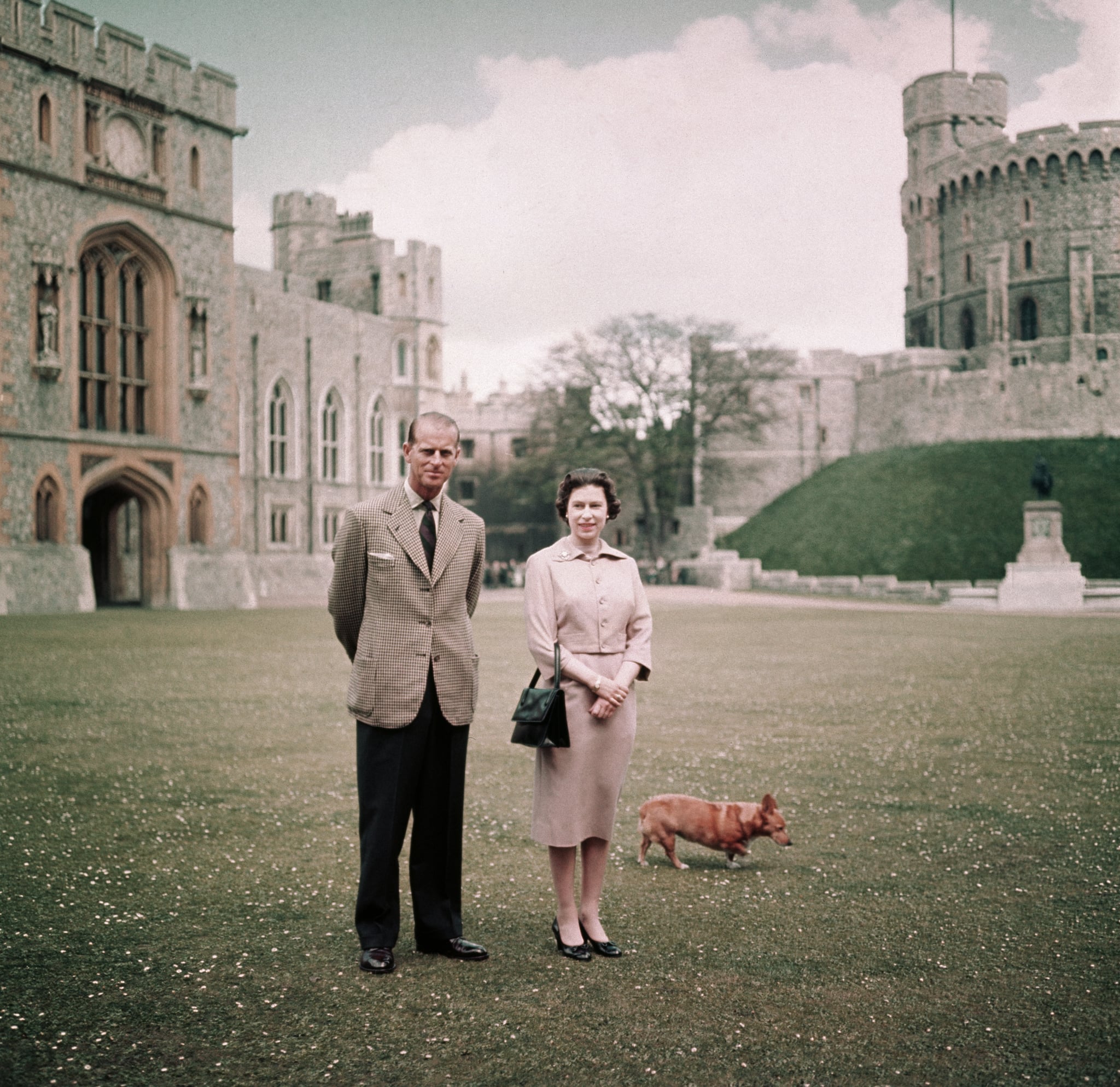 Queen Elizabeth, Prince Philip, and one of their corgis at Windsor Castle in 1959