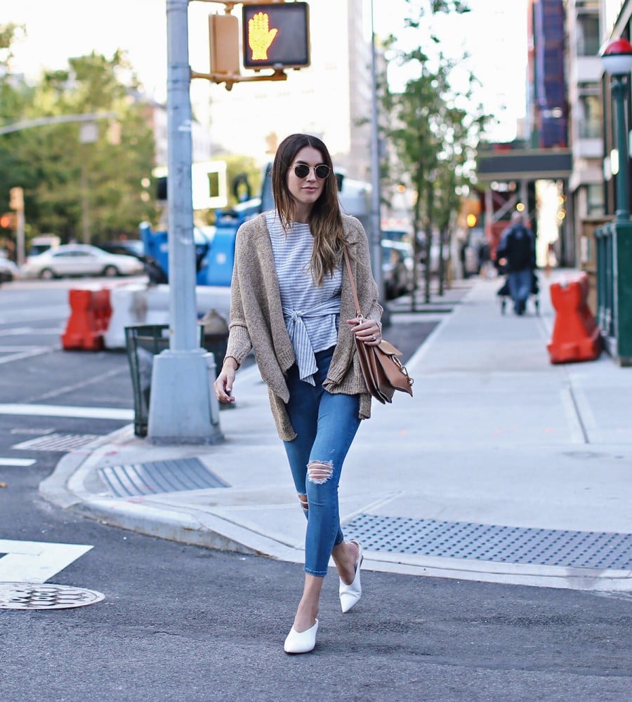 A tie-front top with a cardigan, jeans, and a statement bag.