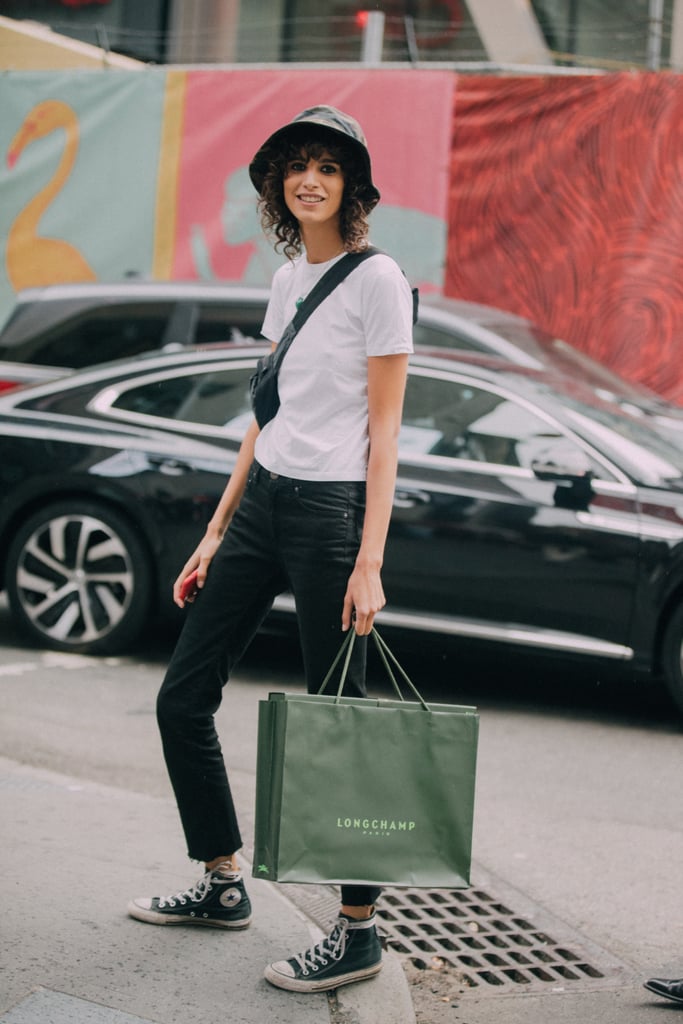 A white t-shirt and jeans feel fresh with a bucket hat and high-top sneakers.