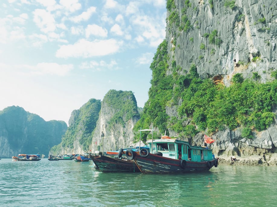 "Grouping complementary colors together can cast a hue over the whole photo. The blues of the boat and water mix with the greens of the rocks to paint the scene in a teal patina."