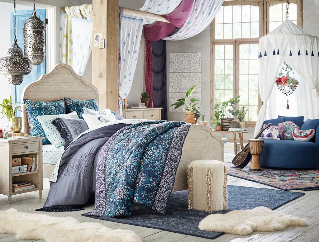 Products pictured: Medallion Tapestry Quilt + Sham ($36-$209), Indigo Printed Overdye Rug ($169-$699), Free Spirit Canopy ($199),  Embroidered Sheer ($69-$99), Embroidered Tassel Duvet Cover + Sham ($36-$189)