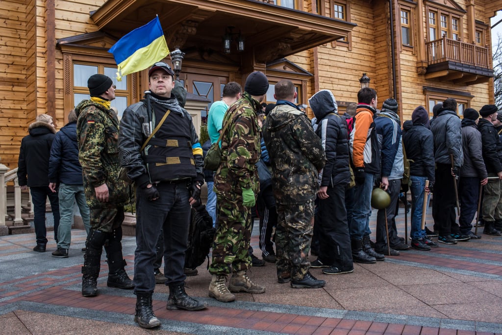 Members of the public lined up outside a house on the estate.