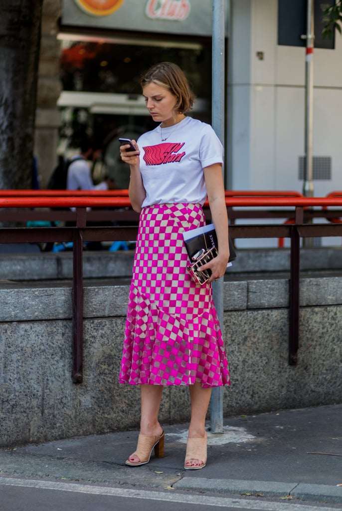Dress down a skirt with easy mules and a t-shirt for casual vibes that speak to Summer.