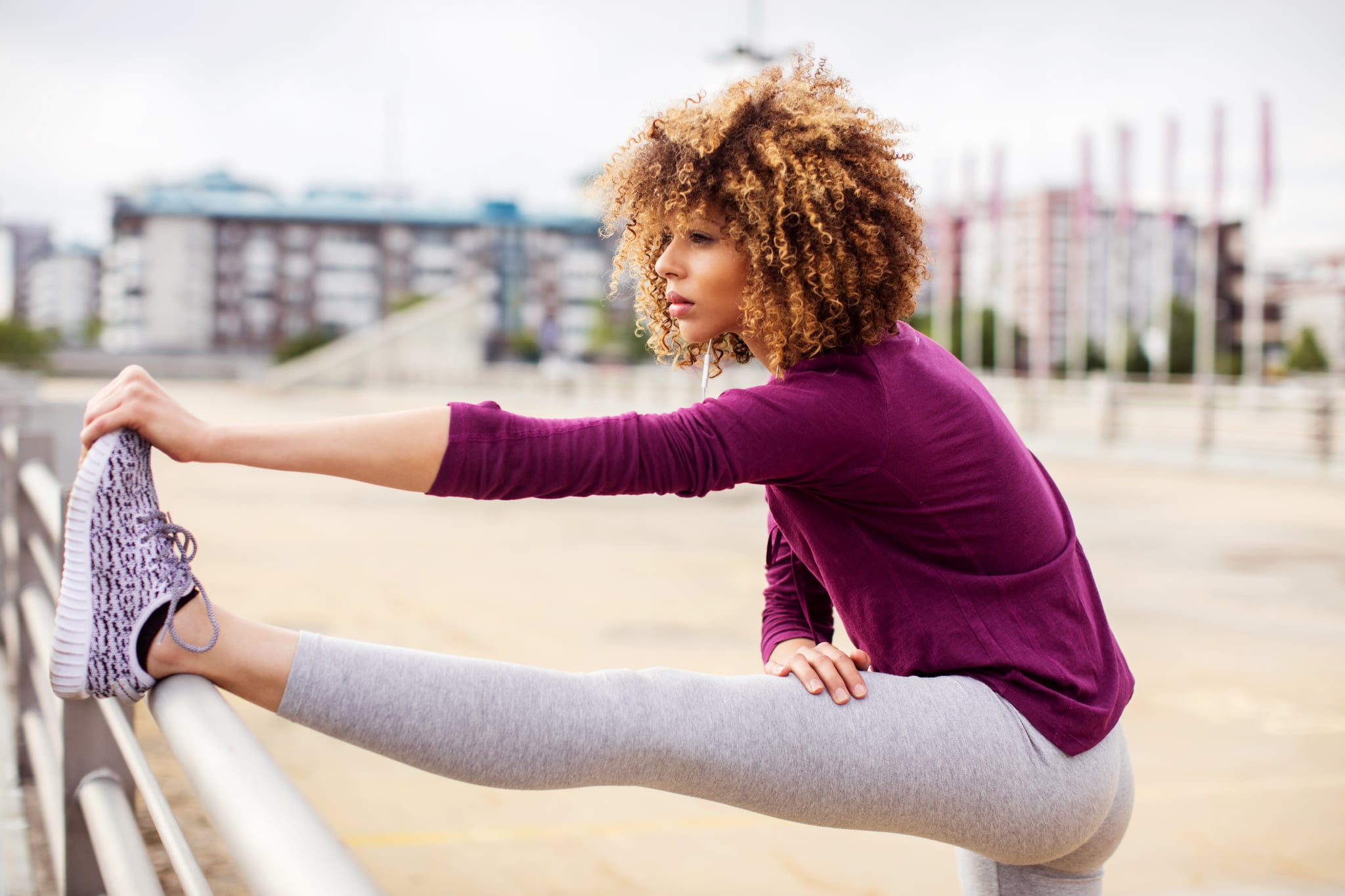 Close up of a young woman stretching