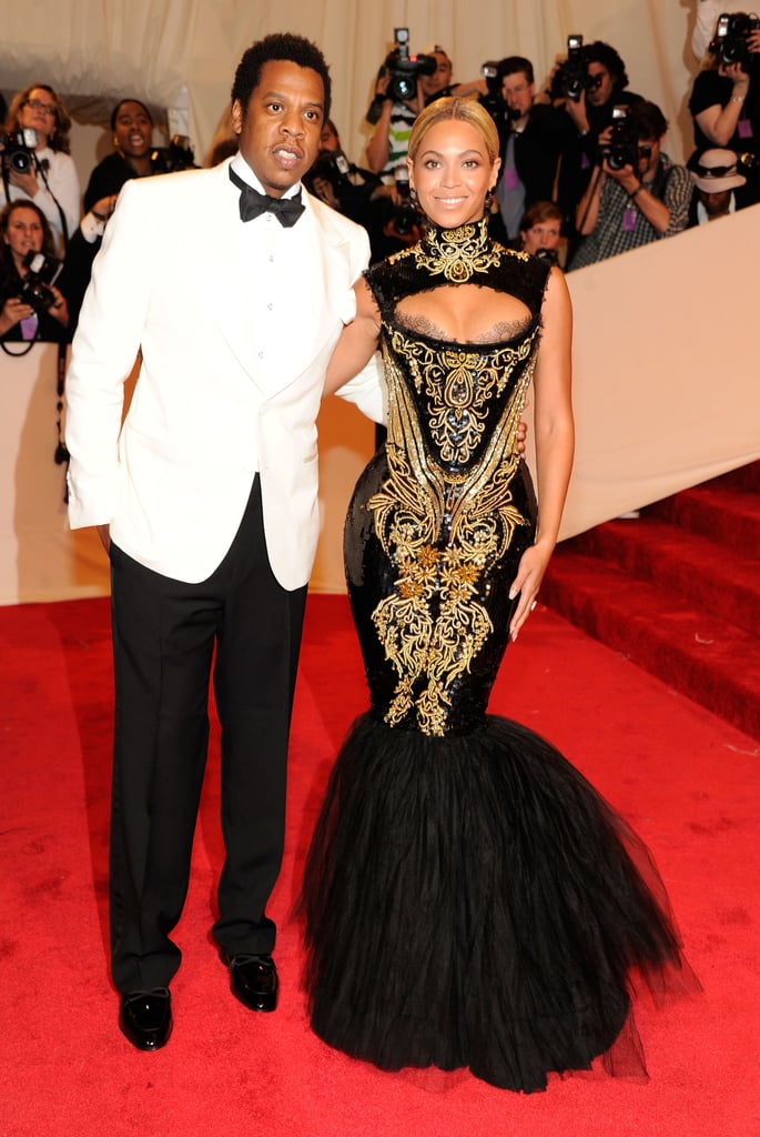 At the 2011 Met Gala in NYC, Beyoncé looked exquisite in a black-and-gold Alexander McQueen gown while JAY-Z looked sharp in a white tuxedo jacket.