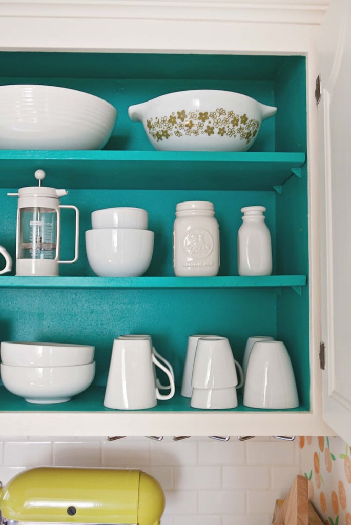 If you have a slightly obsessive habit of only buying white dishware, do yourself a favor and paint the inside of your cabinets a wild color you'd never have the guts to put anywhere else.