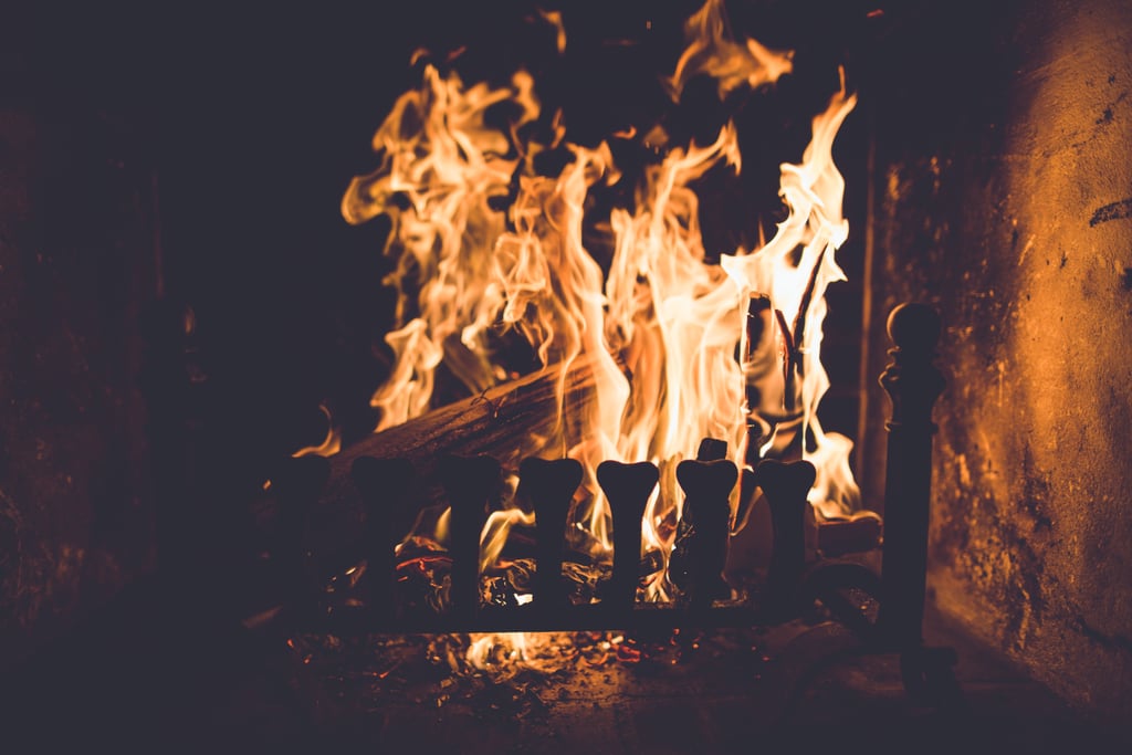 Sitting by a fire.