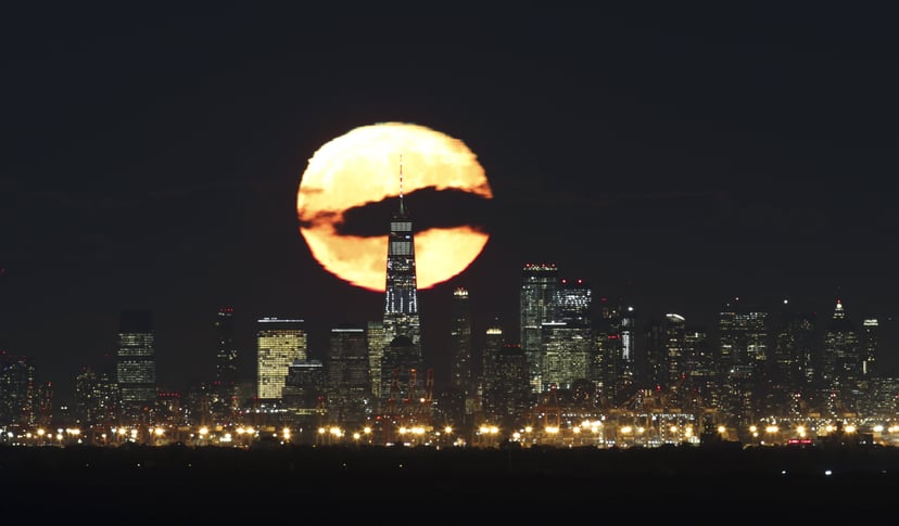 GREEN BROOK TOWNSHIP, NJ - OCTOBER 25: One day after the full Hunter's Moon, the moon rises behind lower Manhattan and One World Trade Center in New York City on October 25, 2018, as seen from Green Brook Township, New Jersey. (Photo by Gary Hershorn/Gett