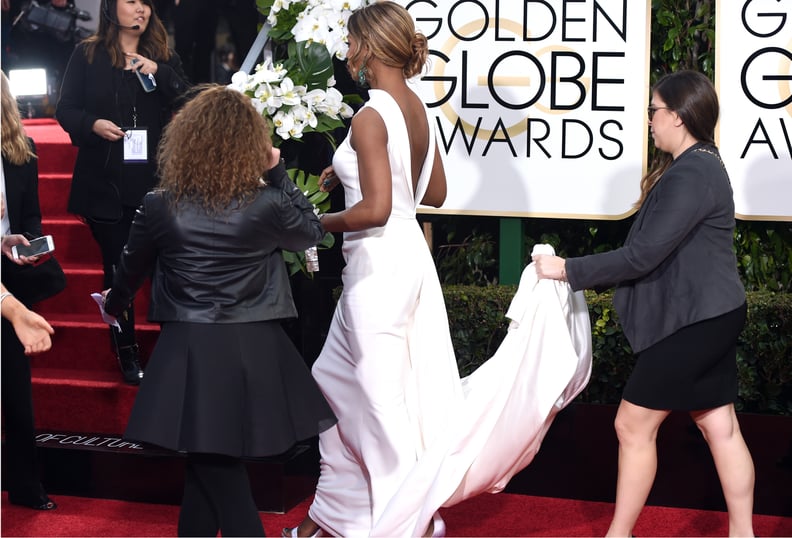 Laverne Cox got a hand with her train up the stairs.