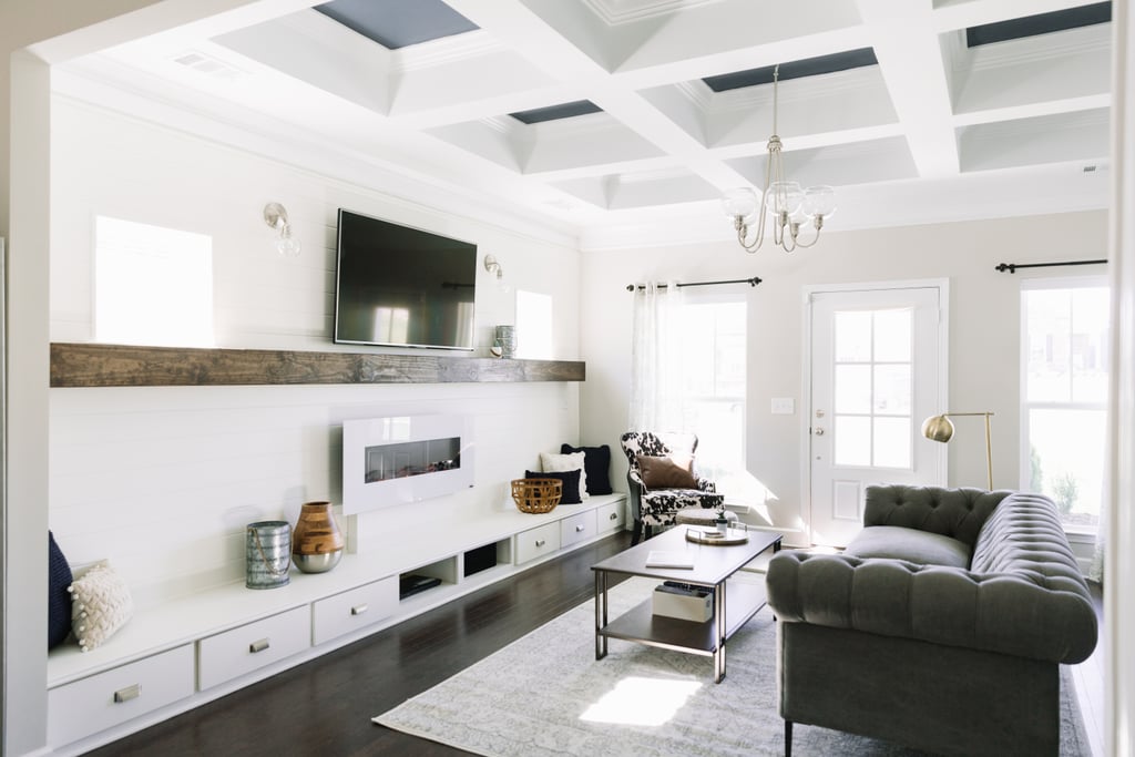 The coffered ceilings were already in place, but Monica made them pop by painting the inside of them denim blue. Then, she swapped out a boring ceiling fan light fixture for an industrial clear glass tiered chandelier ($189). An airy white rug ($180) lays the groundwork for a cozy seating area.