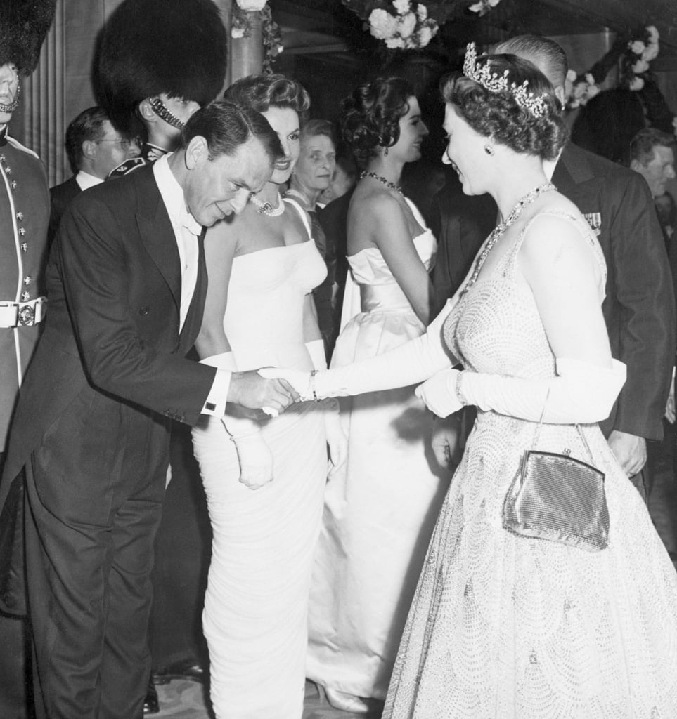 Frank Sinatra bowed to Queen Elizabeth II as she arrived for the premiere of Me and the Colonel in 1958.