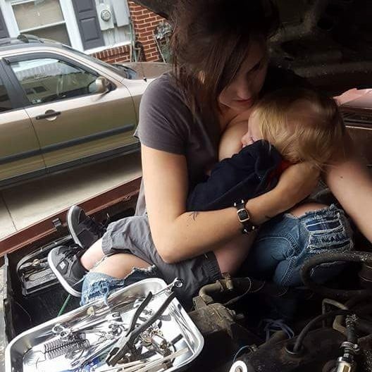 Mom Breastfeeding While Fixing Truck Engine