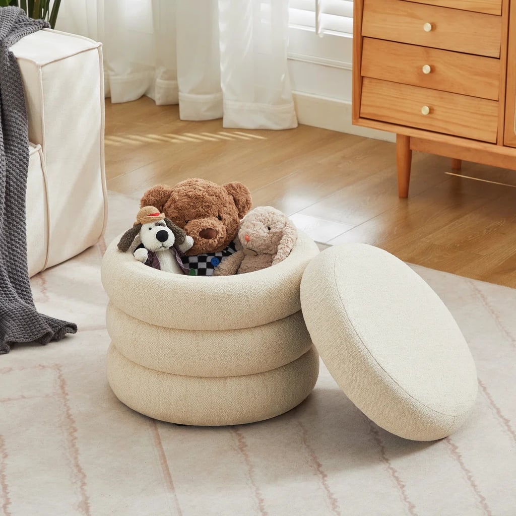 Ebern Designs Leiani Modern Round Upholstered Storage Ottoman ($128, originally $230)
Consider this your reminder that you don't have to sacrifice style for storage. While it might first appear like a typical round ottoman, hidden inside is the perfect hiding spot for spare toys, linens, or seasonal accessories that tend to float around the room.