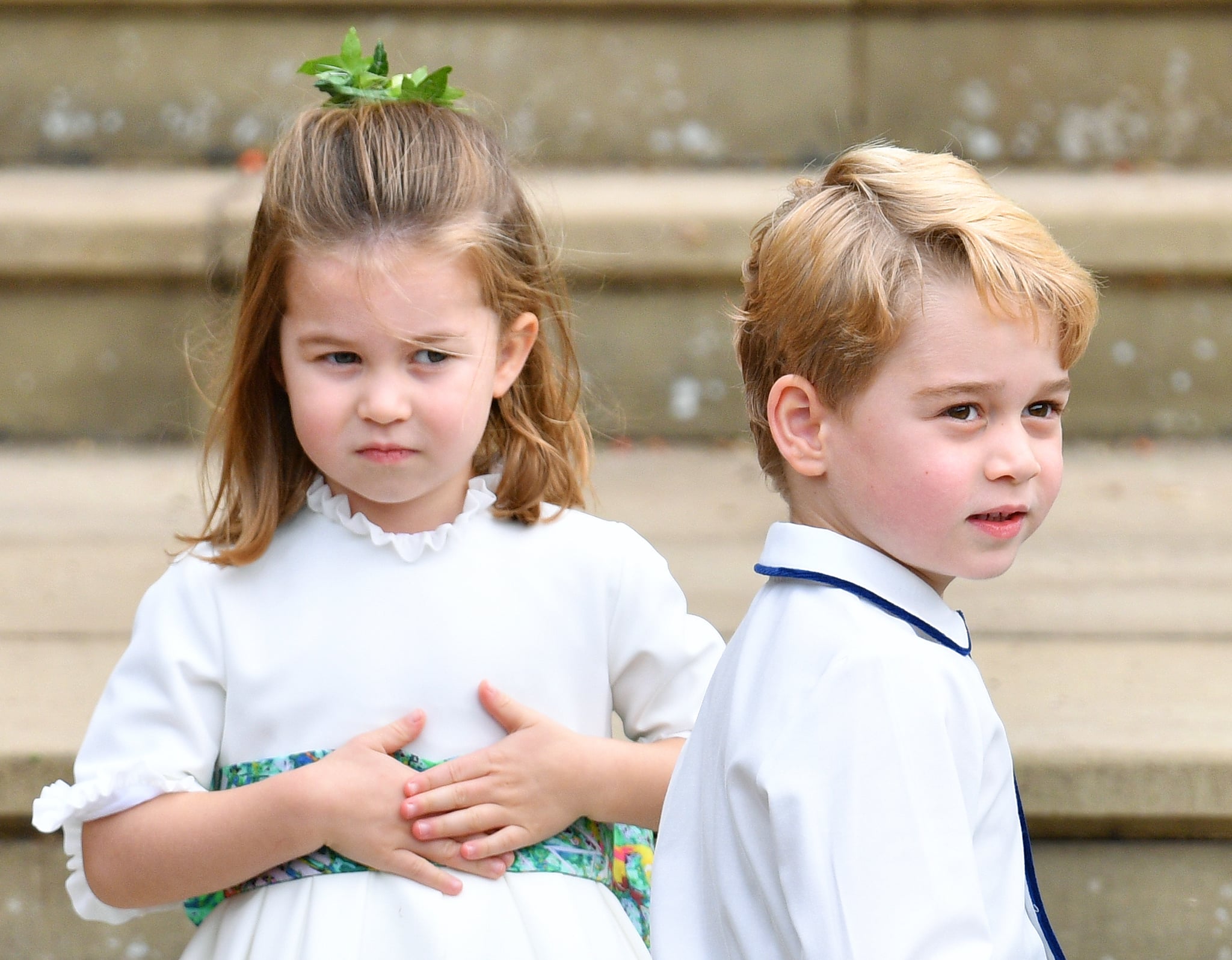 WINDSOR, UNITED KINGDOM - OCTOBER 12: (EMBARGOED FOR PUBLICATION IN UK NEWSPAPERS UNTIL 24 HOURS AFTER CREATE DATE AND TIME) Princess Charlotte of Cambridge and Prince George of Cambridge attend the wedding of Princess Eugenie of York and Jack Brooksbank at St George's Chapel on October 12, 2018 in Windsor, England. (Photo by Pool/Max Mumby/Getty Images)