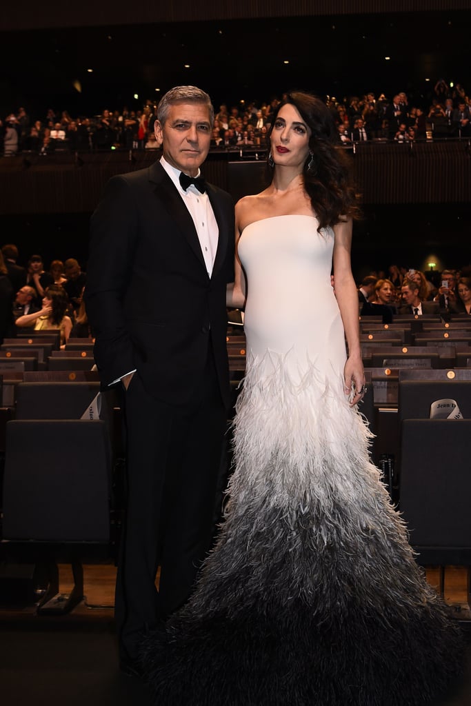 Amal's bump made its red carpet debut in this stunning feathered gown, a custom Versace creation.