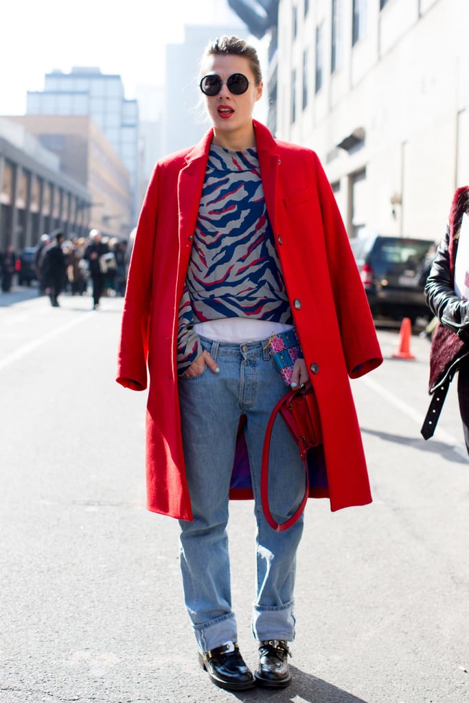 A fiery red coat reflected the same bright hues in her animal-print top.
A fiery red coat reflected the same bright hues in her animal-print top.
