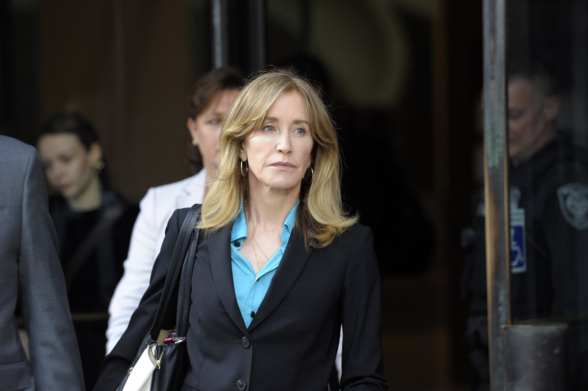 Actress Felicity Huffman exits the courthouse after facing charges for allegedly conspiring to commit mail fraud and other charges in the college admissions scandal at the John Joseph Moakley United States Courthouse in Boston on April 3, 2019. (Photo by Joseph Prezioso / AFP)        (Photo credit should read JOSEPH PREZIOSO/AFP/Getty Images)