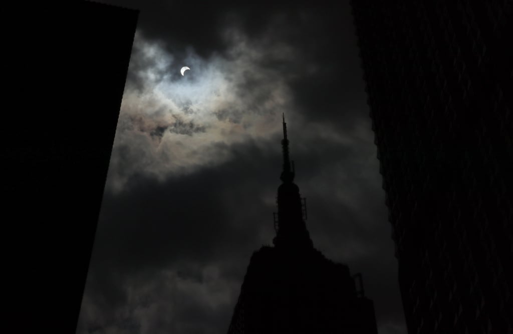 The solar eclipse plunges the Empire State Building into darkness.