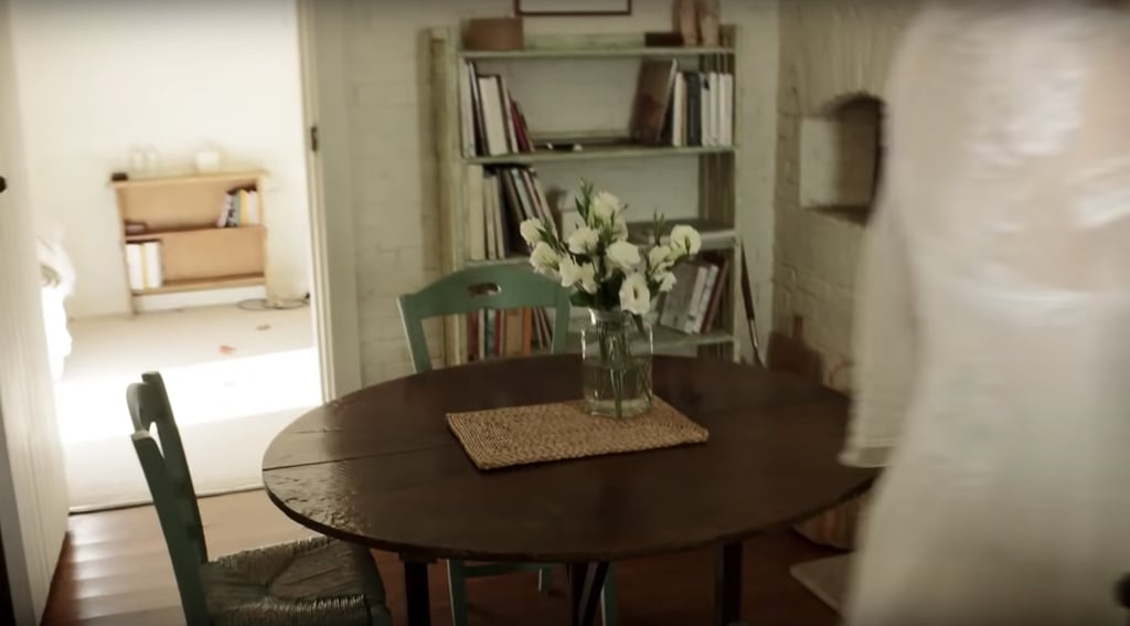 Inside, the cottage has a charming little table with a bookshelf.