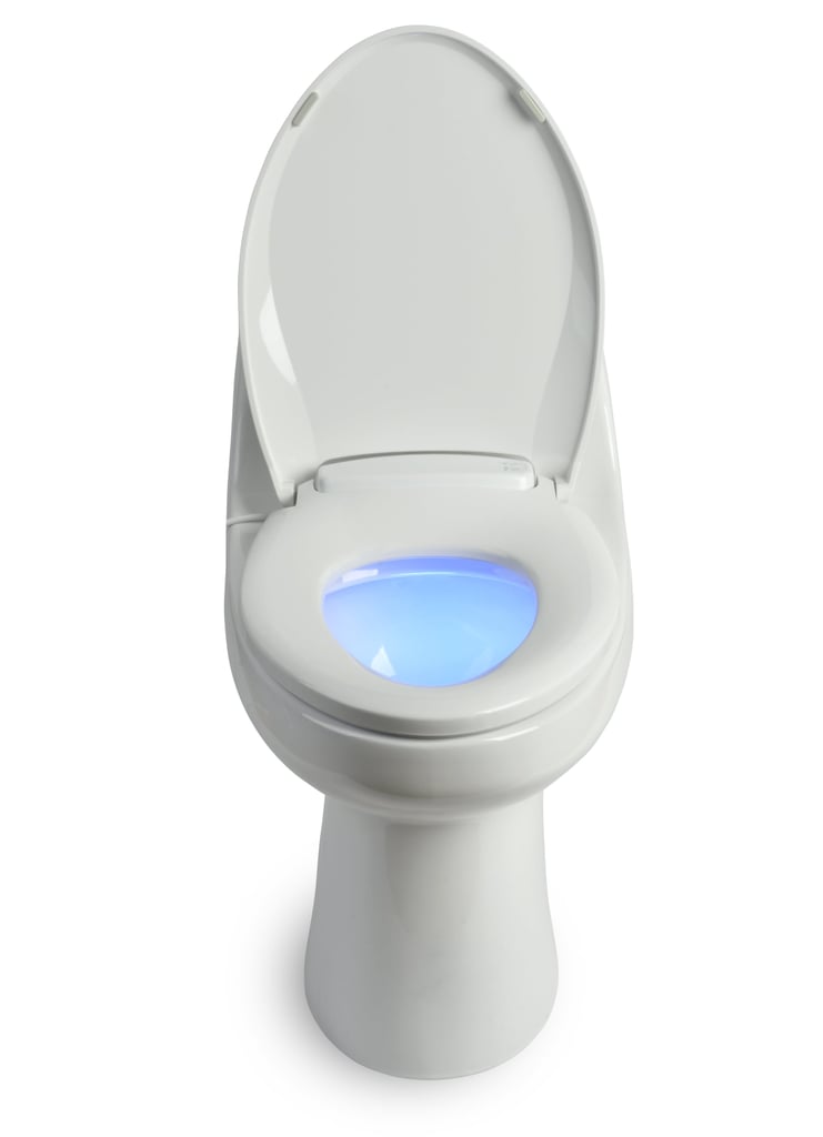 "My apartment doesn't have a heater, so needless to say, my morning bathroom stop is pretty chilly. Recently, my toilet seat was in desperate need of a replacement, so my roommates and I decided to check out our options on Amazon and discovered this Brondell LumaWarm Heated Nightlight Toilet Seat ($136). We were so excited about the idea of being able to afford what felt like a luxury item, so, without hesitation, we ordered it. 
The seat comes in two sizes, elongated and round, which was a foreign concept to me, but after a quick Google search, I learned that toilets are, in fact, made in two different shapes and you can figure out which one you have by measuring the length of your current seat.
It arrived within just a few days and was easy to install — all we needed was a screwdriver. In order for it to work, we made sure we had an outlet close to the toilet because it is powered by plugging into the wall. It features three different heat settings and even a blue nightlight. We instantly fell in love with it. Sitting on a regular toilet just doesn't feel the same anymore. It was worth every penny." — KJ