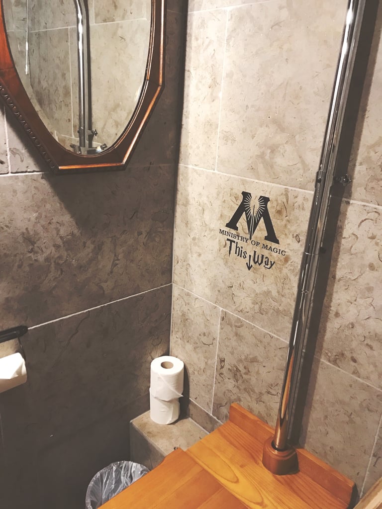 There is a very helpful sign for entrance to the Ministry of Magic beside the toilet. As you can see, the only downside to the bathroom is the poorly placed mirror that requires standing on the toilet to use. (It's also the only usable mirror in the room.)