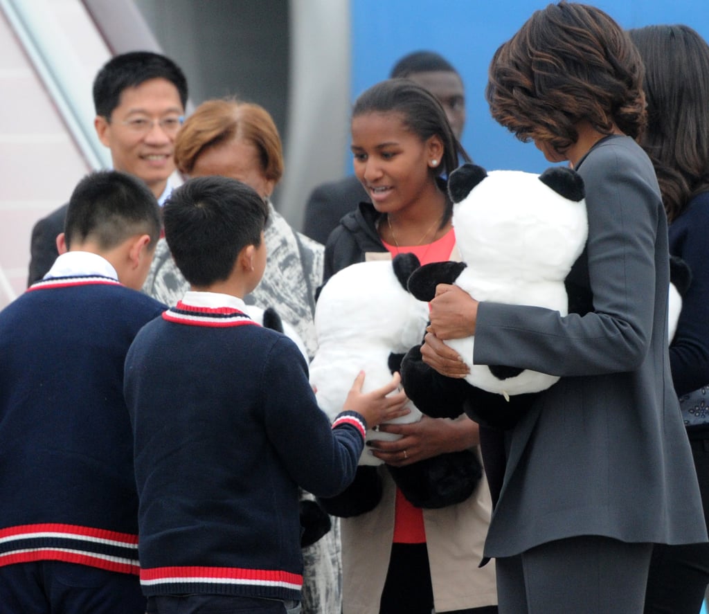 When the group touched down in Chengdu, children gave them panda stuffed animals.