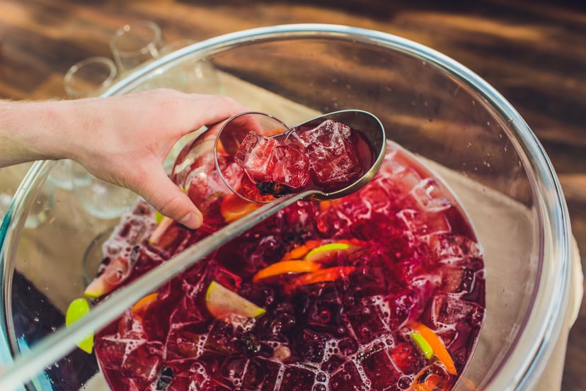 A large bottle of cold sangria with a ladle: what are the best fruits for sangria?