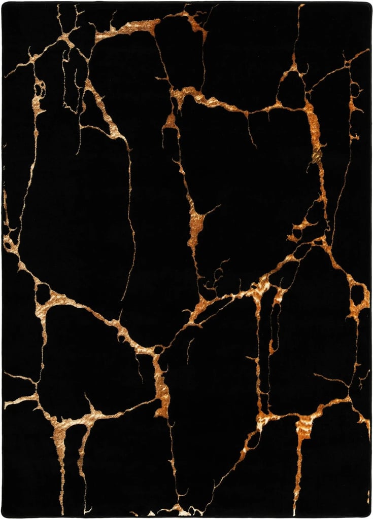 Rugs.com Black and Gold Vogue Geo Rug ($99, originally $269)
Nothing sets a moodier tone for guests or trick-or-treaters than throwing down a dark area run in your entryway. This black-and-gold marble design feels equal parts eerie and elevated, making it the perfect unobvious Halloween decoration.