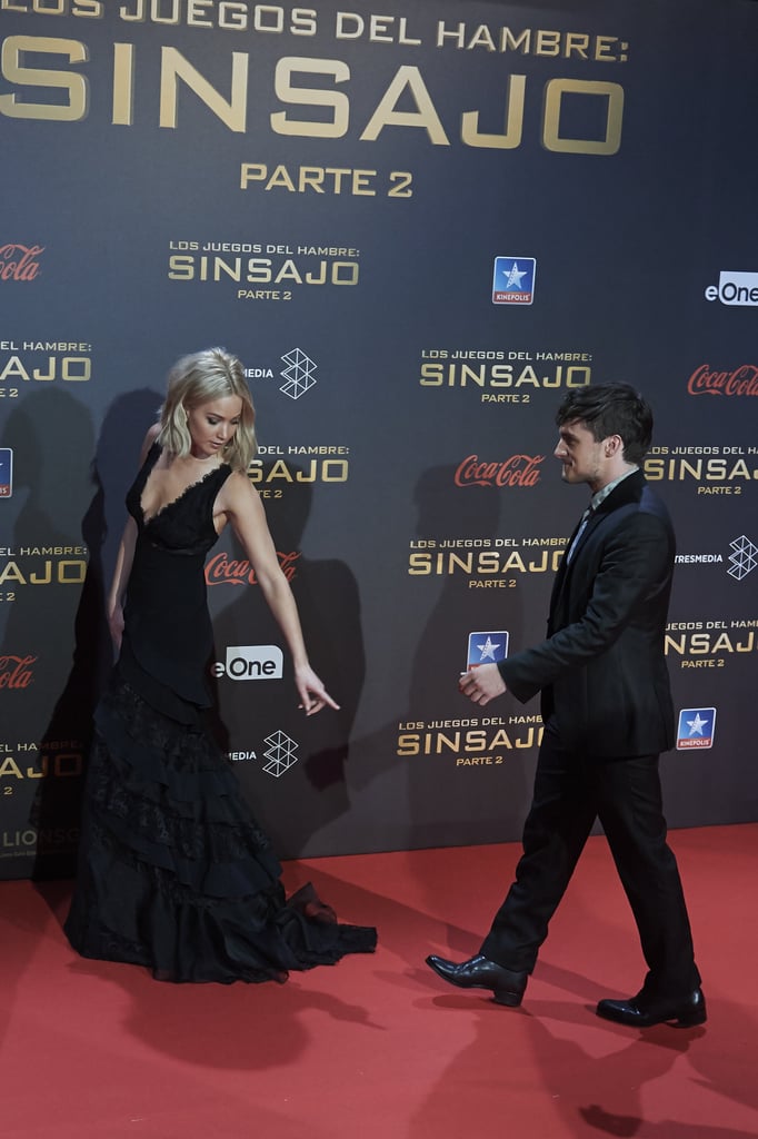 She politely instructed Josh Hutcherson to watch her lovely train on the carpet.