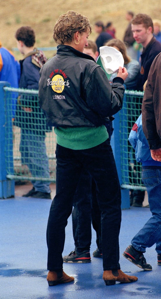 Spending the day with her sons at Thorpe Park, Diana's throw-on style included dark denim jeans, a green knitted jumper, and an enviable Hard Rock cafe leather bomber jacket.