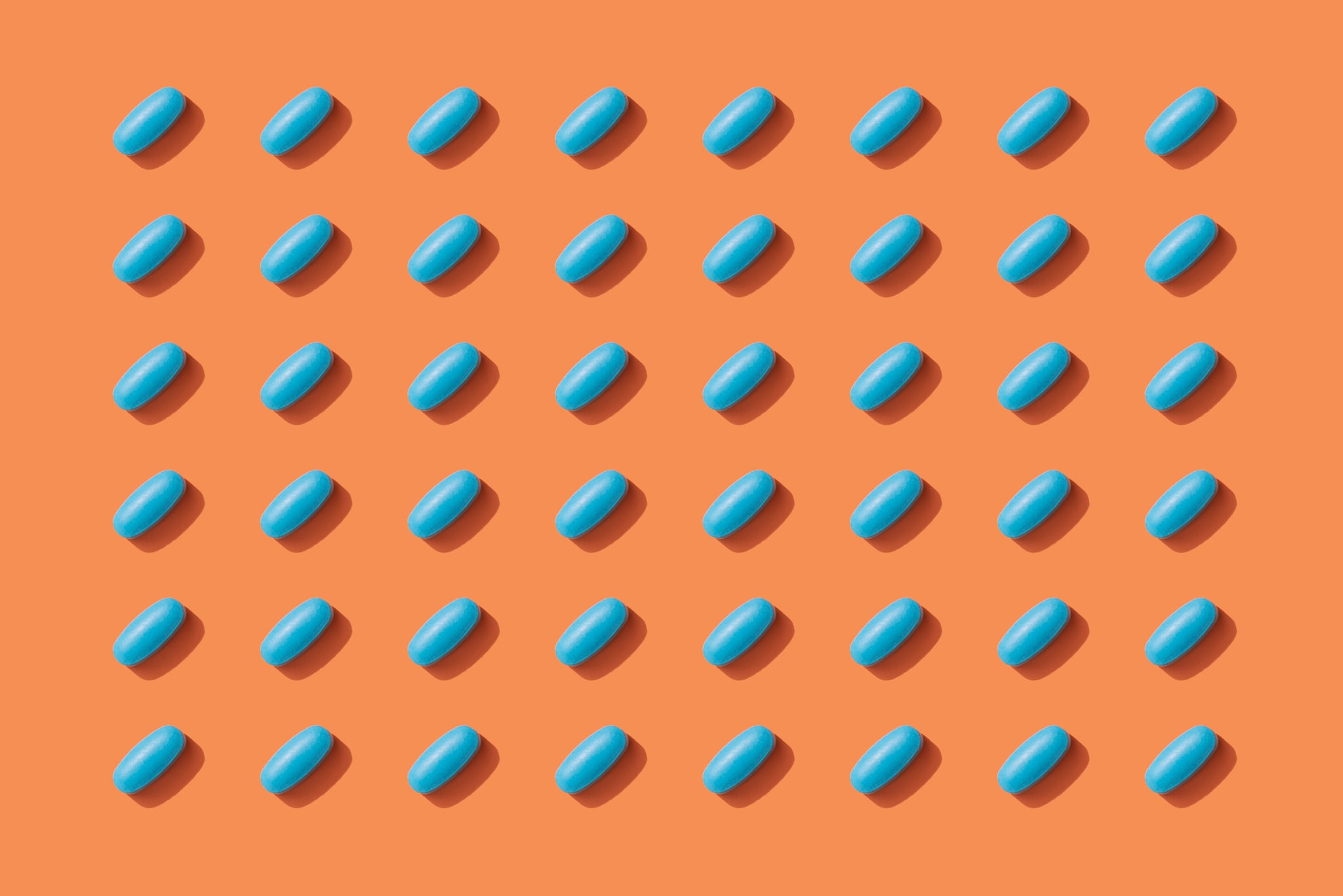 Repeated Pills on Orange Colour Background