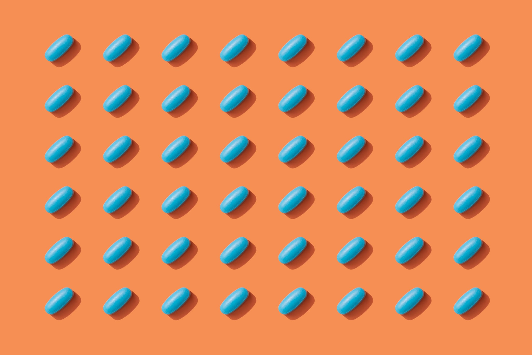 Repeated Pills on Orange Color Background