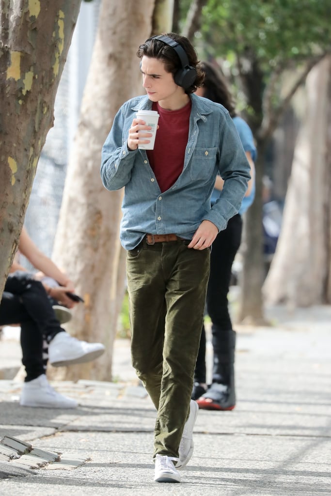 Listening to some tunes in corduroy pants, a red t-shirt, and chambray shirt on top.