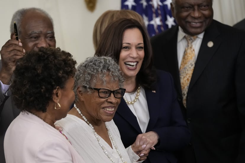 WASHINGTON, DC - JUNE 17: (L-R) 94-year-old activist and retired educator Opal Lee, known as the Grandmother of Juneteenth, holds hands with Vice President Kamala Harris as U.S. President Joe Biden signs the Juneteenth National Independence Day Act into l