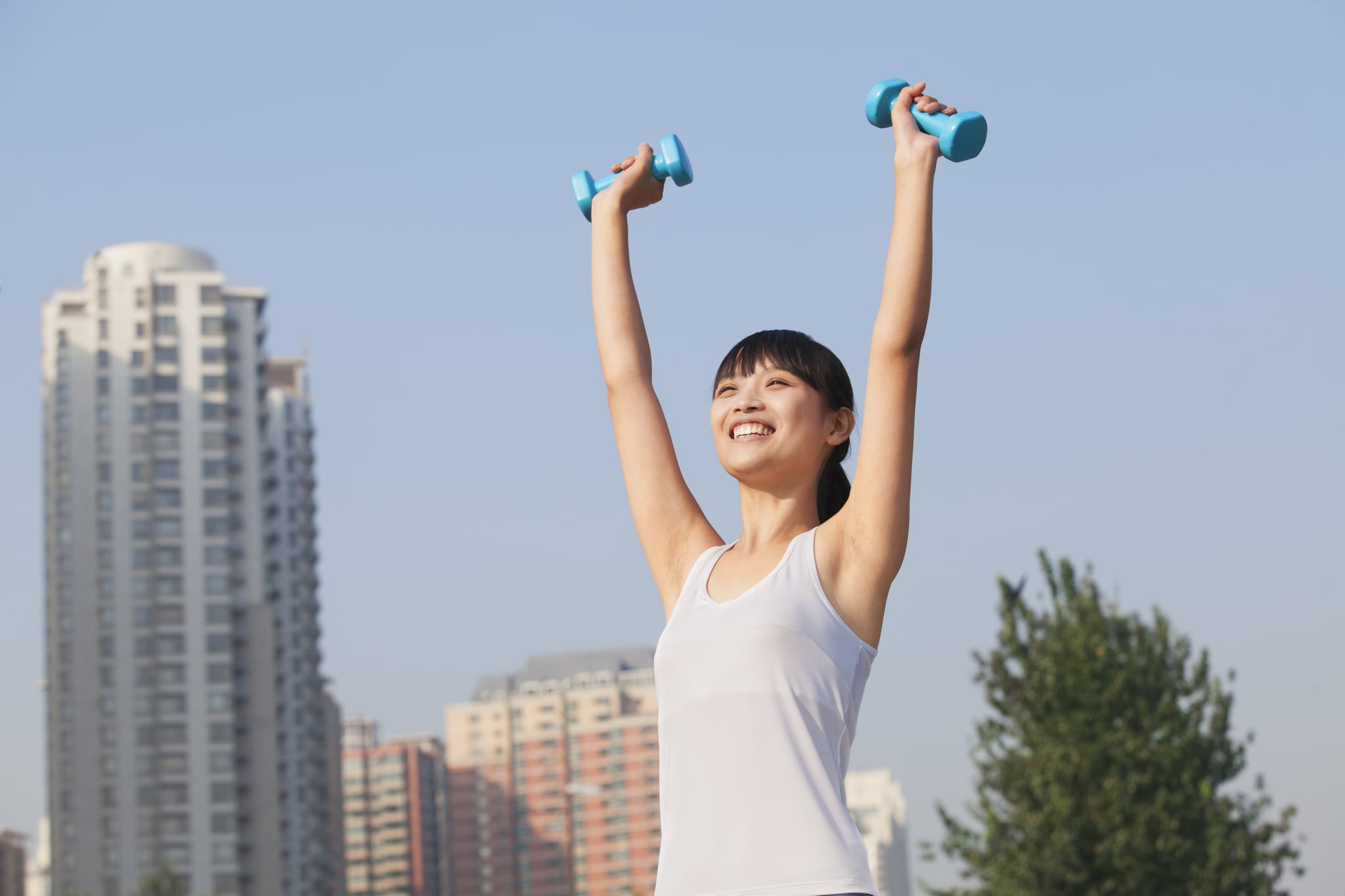 Chinese woman lifting dumbbells