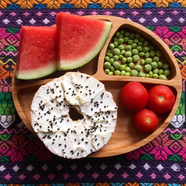 "Lunch: watermelon, sugar snap pea pods, cherry tomatoes, and an everything bagel with cream cheese and black sesame seeds."