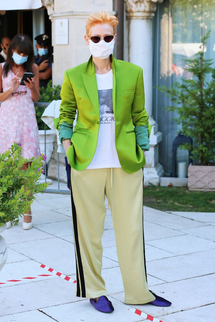 Tilda Swinton posed in a bright tuxedo jacket and trousers on day two.