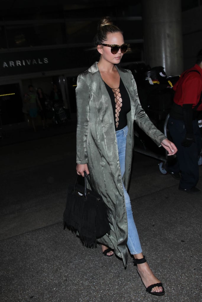 Chrissy Wore a Long Duster With a Lace-Up Shirt and Jeans While Traveling