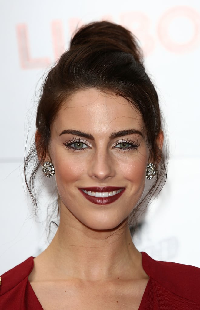 To add softness to your topknot, just add face-framing tendrils, like Jessica Lowndes shows here.