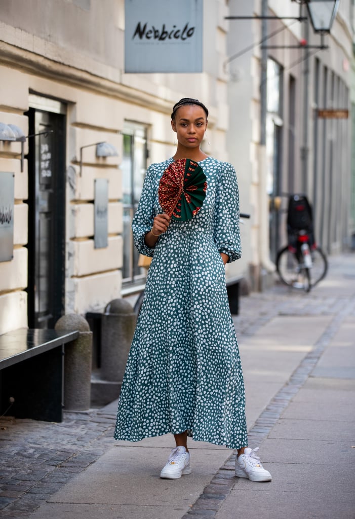 Pair a puff-sleeve maxi dress with white trainers and a fabulous fan