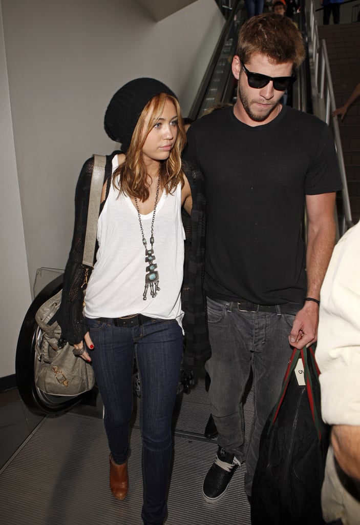 Miley Cyrus and Liam Hemsworth stuck together at LAX in June 2010.