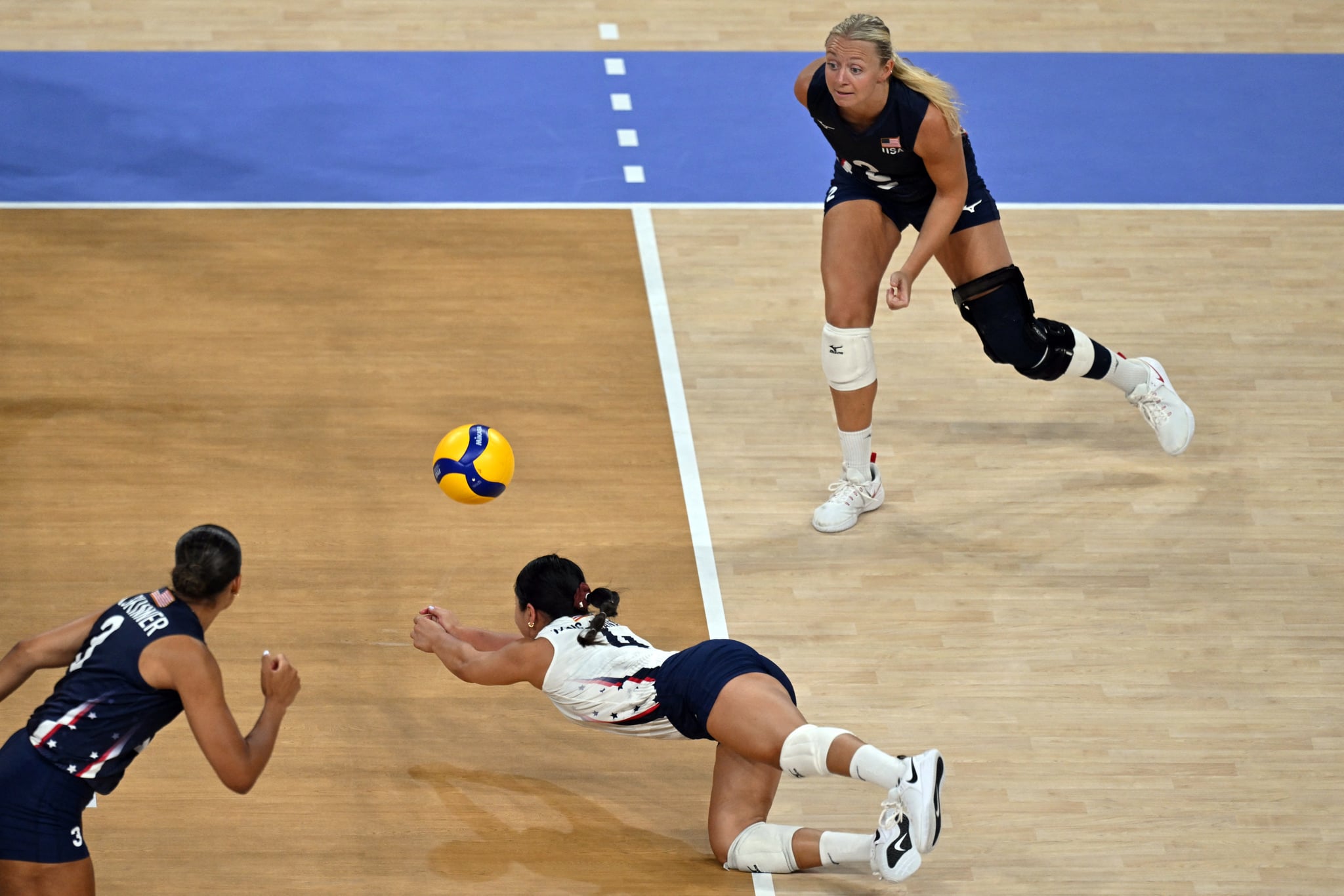 US' #04 Justine Wong-Orantes jumps to pass the ball during the women's preliminary round volleyball match between USA and China during the Paris 2024 Olympic Games at the South Paris Arena 1 in Paris on July 29, 2024. (Photo by Andrej ISAKOVIC / AFP) (Photo by ANDREJ ISAKOVIC/AFP via Getty Images)