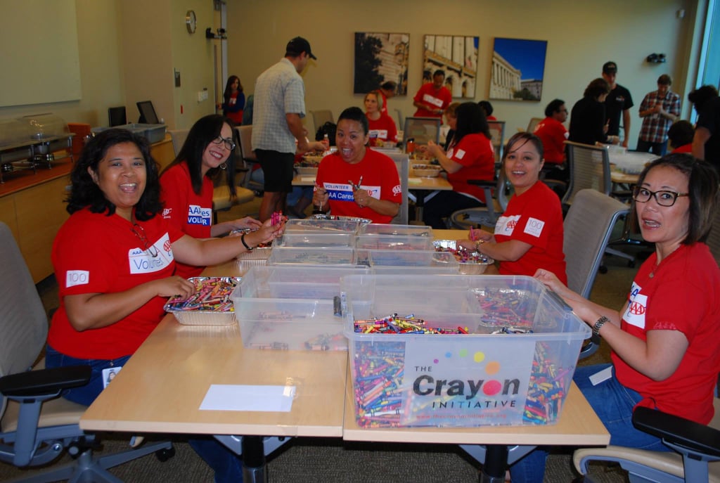Volunteers sort through the boxes by color.