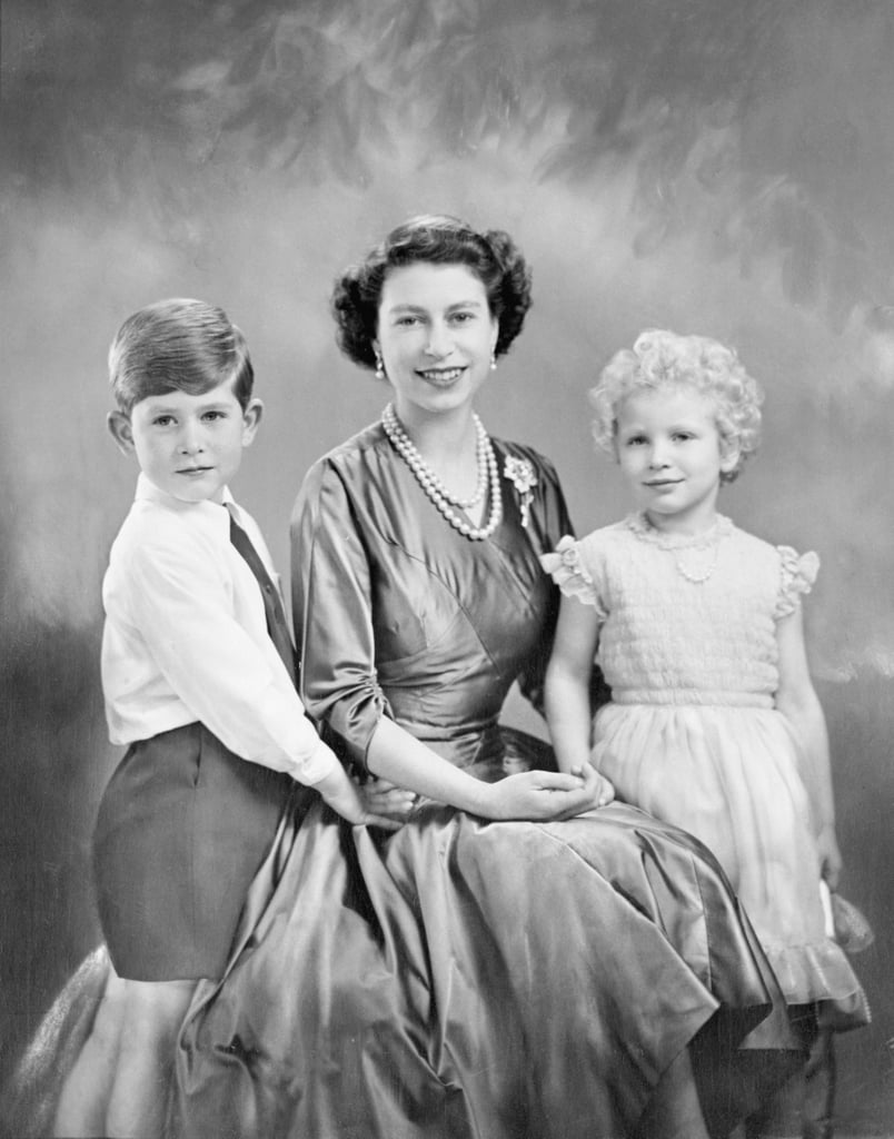 The Queen posed for a formal portrait with her oldest two children, Charles and Anne, in 1954.