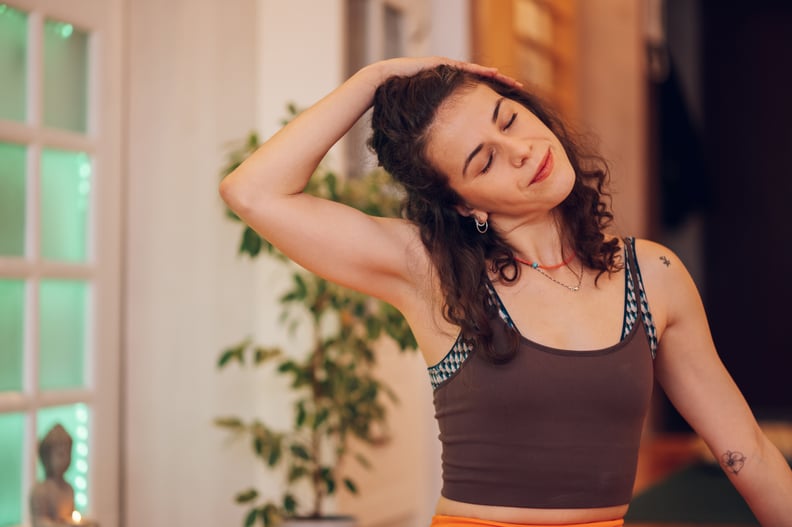 woman stretching, contemplating working out while sick