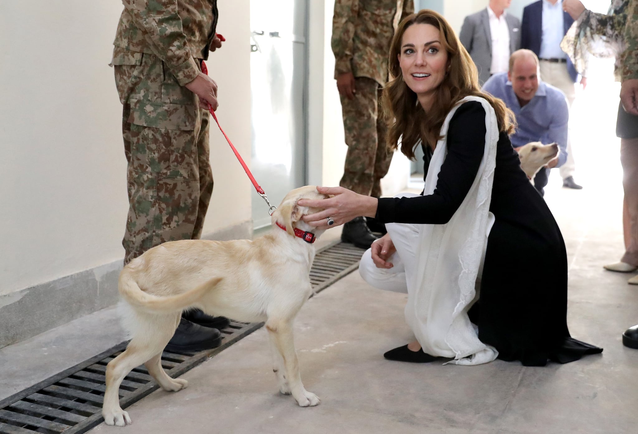 ISLAMABAD, PAKISTAN - OCTOBER 18:  Catherine, Duchess of Cambridge with golden labrador puppies Salto and Sky as she visits an Army Canine Centre with Prince William, Duke of Cambridge, where the UK provides support to a programme that trains dogs to identify explosive devices, during day five of their royal tour of Pakistan on October 18, 2019 in Islamabad, Pakistan. (Photo by Chris Jackson - Pool/Getty Images)