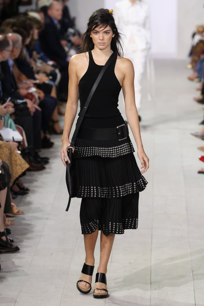 On the Michael Kors runway, Kendall sported an edgy all-black ensemble that included rivet details and an oversize belt slung low on her waist.