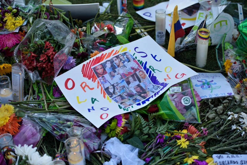 Photos and flowers are seen at a memorial at the Dr. Phillips Center for the Performing Arts to honor the Pulse nightclub mass shooting victims June 14, 2016 in Orlando, Florida.The gunman who launched the worst terror attack on US soil since 9/11 at a ga