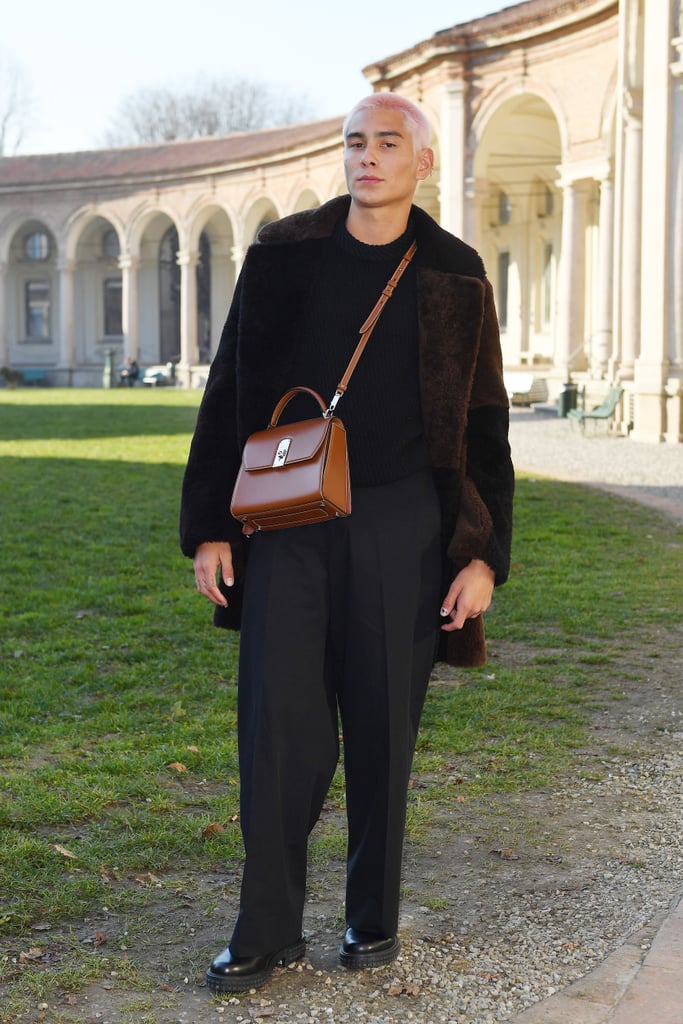 Styling a monochrome outfit with a brown leather Salvatore Ferragamo bag.