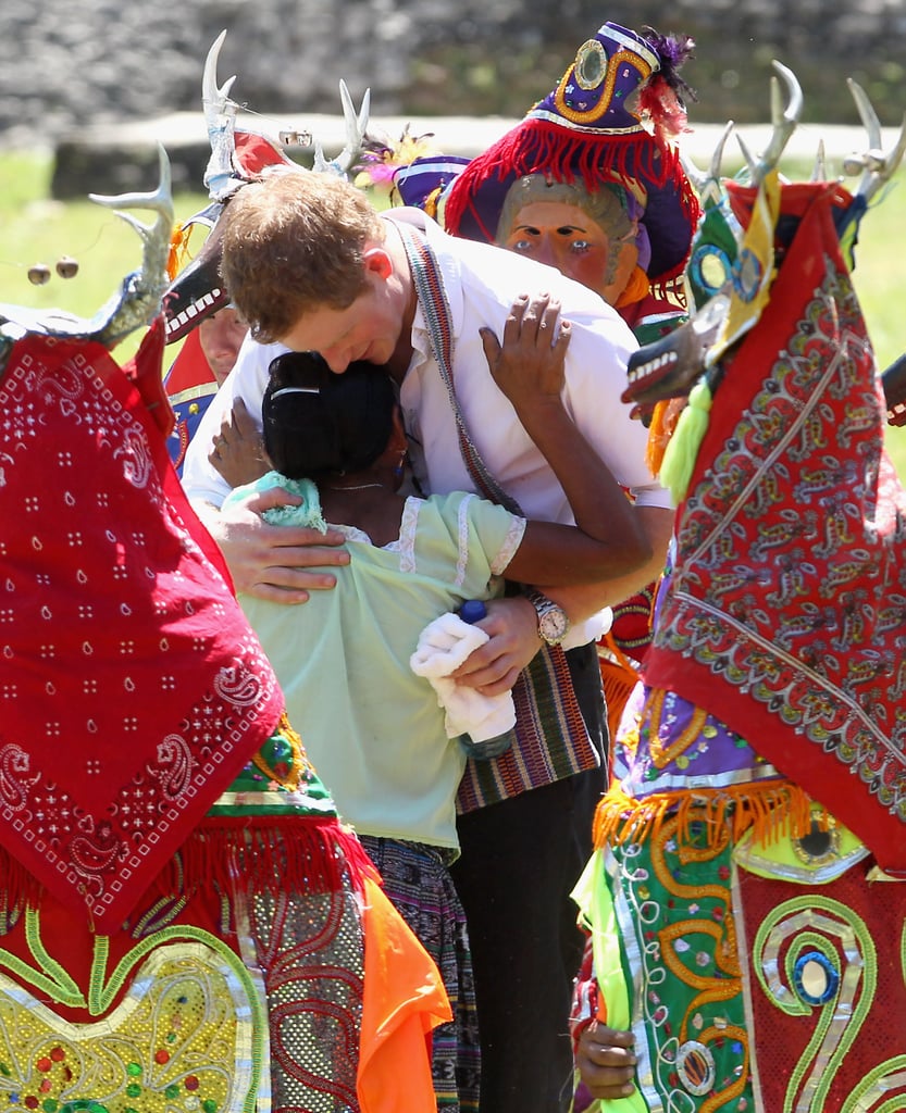 Harry hugged a girl among deer dancers during a visit to the Xunatunich Mayan Temple in 2012.